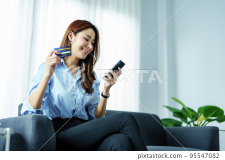 Online Shopping and Internet Payments, Portrait of Asian woman are using their mobile phones and credit cards to shop online or conduct errands in the digital world Online Shopping and Internet Payments, Portrait of Asian woman are using their mobile phones and credit cards to shop online or conduct errands in the digital world 95547082