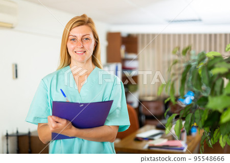 Female doctor assistant standing in medical office Female doctor assistant standing in medical office 95548666