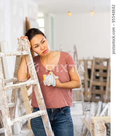 Portrait of overworked asian woman, house renovation Portrait of overworked asian woman, house renovation 95548682