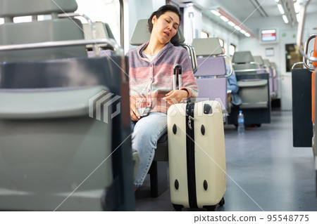 Tired asian woman fell asleep in subway car 95548775