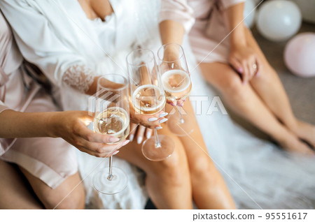 Beautiful bride and sexy girlfriends have fun on the morning of the wedding day Beautiful bride and sexy girlfriends have fun on the morning of the wedding day 95551617