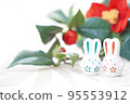 Rabbit figurine and camellia 95553912