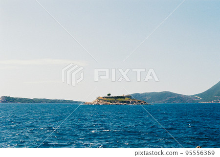 Lustica peninsula with Arza fortress against the backdrop of mountains. Montenegro 95556369