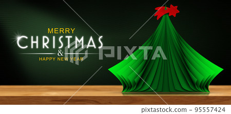 Small Paper Christmas Tree with a Red Comet Star on the Table 95557424