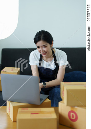Starting small business entrepreneur of independent Asian woman smiling using laptop computer with cheerful success of online marketing package box items and SME delivery concept. Starting small business entrepreneur of independent Asian woman smiling using laptop computer with cheerful success of online marketing package box items and SME delivery concept. 95557765