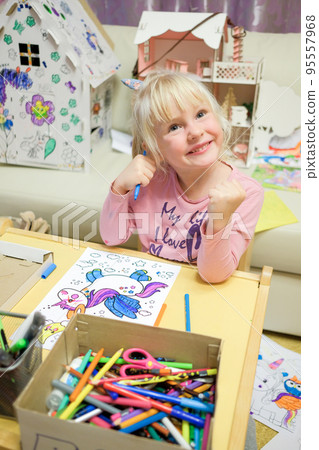 A cheerful child is engaged in fine art. A cheerful child is engaged in fine art. 95557968