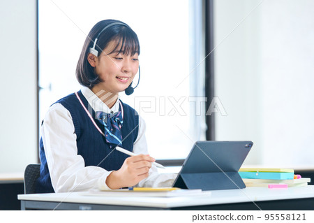 Junior high school students studying on tablets 95558121