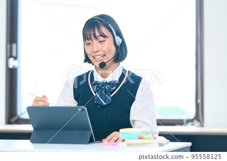 Junior high school students studying on tablets 95558125