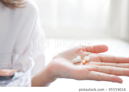 Woman taking medicine Woman taking medicine 95559016
