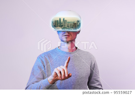 Man uses virtual reality glasses to go to another point of world. 95559027