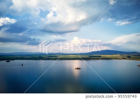Aerial top view of beautiful landscape with large lake against mountains shapes at summer day. Mietkow lake near Wroclaw, Poland 95559749