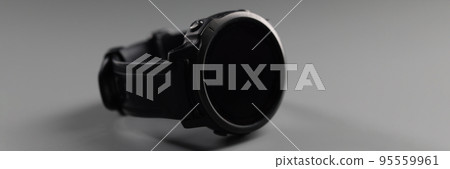 Black male wrist sports watch lying on grey background, stylish minimalistic device Black male wrist sports watch lying on grey background, stylish minimalistic device 95559961