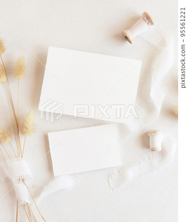 Blank cards near silk ribbons and dried hare's tail grass top view on white, boho mockup Blank cards near silk ribbons and dried hare's tail grass top view on white, boho mockup 95561221