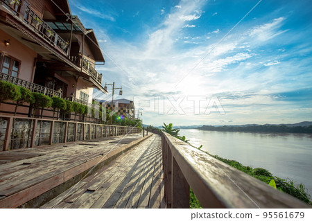 The scenery of the  Mekong River and walkway with lens flair in Chiang Khan. 95561679