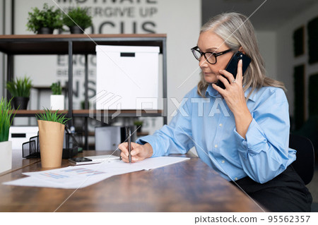 adult business woman working in office talking on mobile phone. Business Invoice Tax Management 95562357