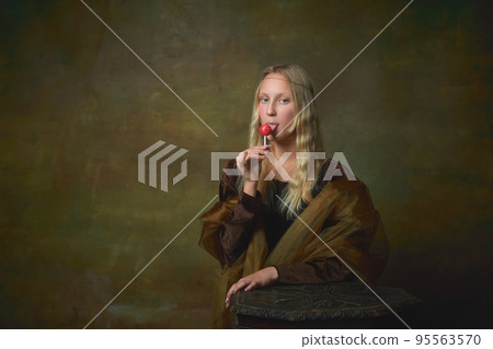 Candy. Vintage style portrait of young charming girl in image of Mona Lisa, La Gioconda isolated on dark green background. Art, beauty, style, imitation Candy. Vintage style portrait of young charming girl in image of Mona Lisa, La Gioconda isolated on dark green background. Art, beauty, style, imitation 95563570