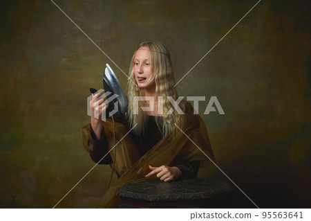 Acute experience. Vintage style portrait of young charming girl in image of Mona Lisa isolated on dark green background. Art, beauty, style, imitation Acute experience. Vintage style portrait of young charming girl in image of Mona Lisa isolated on dark green background. Art, beauty, style, imitation 95563641