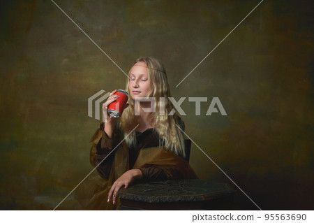 Beautiful young girl with long blonde hair wearing medieval dress posing over dark vintage background. Retro style, art, fashion, comparison of eras concept. Beautiful young girl with long blonde hair wearing medieval dress posing over dark vintage background. Retro style, art, fashion, comparison of eras concept. 95563690