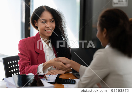 Image black business women handshake. Successful black business women handshaking after good deal. Group support concept 95563873