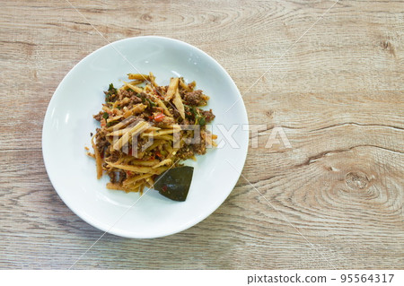 spicy stir fried bamboo shoot and chop beef meat with basil leaf on plate   95564317
