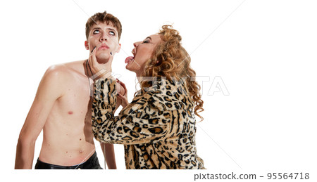Portrait of young man and woman in extraordinary clothes and brights makeup posing isolated over white background 95564718