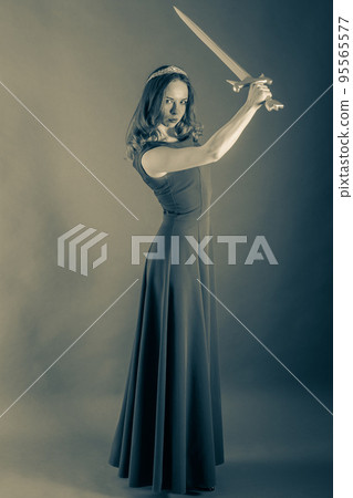 Attractive girl who raised her sword above herself. Halloween sepia toned 95565577
