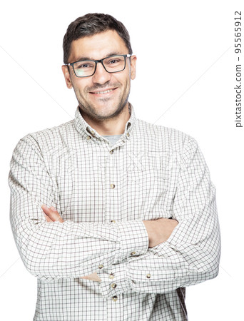 Young man wearing white checkered shirt and glasses standing with crossed arms and smiling. 95565912