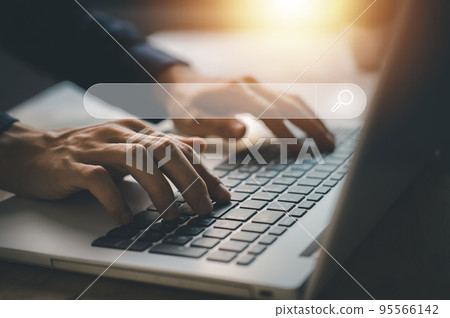 Search engine technology. Businessman typing notebook (Laptop) for search for data information with blank search bar hologram. Searching information data on internet. Search engine technology. Businessman typing notebook (Laptop) for search for data information with blank search bar hologram. Searching information data on internet. 95566142