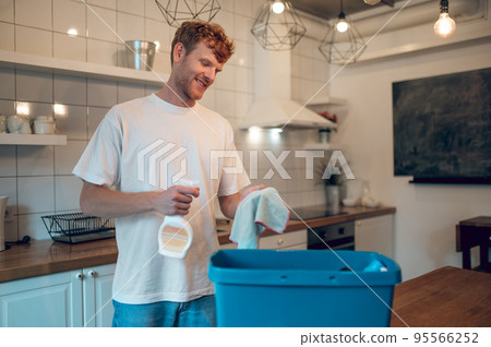 Man doing some housework and cleaning some surfaces 95566252