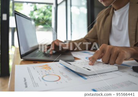 Business man using computer and calculator for calculate financial at home office. Business man using computer and calculator for calculate financial at home office. 95566441