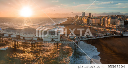 Aerial view of Brighton Palace Pier, with the seafront behind. Aerial shot of the stunning city of Brighton and Hove with seagulls flying around at sunset. Aerial view of Brighton Palace Pier, with the seafront behind. Aerial shot of the stunning city of Brighton and Hove with seagulls flying around at sunset. 95567204