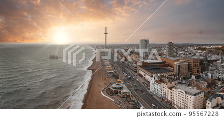 Beautiful Brighton beach view. Magical sunset and stormy weather in Brighton, UK. Town by the ocean in England. 95567228