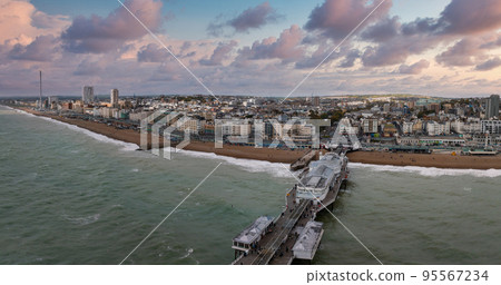 Aerial view of Brighton Palace Pier, with the seafront behind. Aerial shot of the stunning city of Brighton and Hove with seagulls flying around at sunset. Aerial view of Brighton Palace Pier, with the seafront behind. Aerial shot of the stunning city of Brighton and Hove with seagulls flying around at sunset. 95567234
