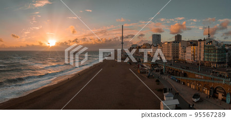 Beautiful Brighton beach view. Magical sunset and stormy weather in Brighton, UK. Town by the ocean in England. Beautiful Brighton beach view. Magical sunset and stormy weather in Brighton, UK. Town by the ocean in England. 95567289