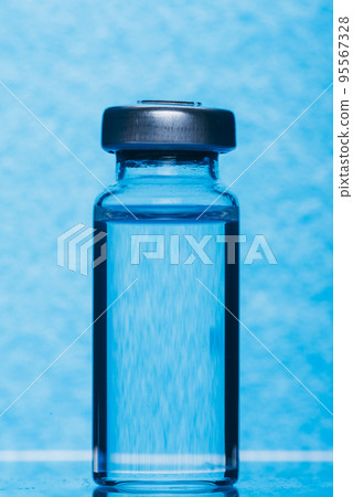 Glass medical ampoule vial for injection. Medicine is liquid sodium chloride with of aqueous solution in ampulla. Close up. Bottles ampule multicolor. Glass medical ampoule vial for injection. Medicine is liquid sodium chloride with of aqueous solution in ampulla. Close up. Bottles ampule multicolor. 95567328