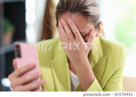Frustrated depressed woman covering face with hand 95570441