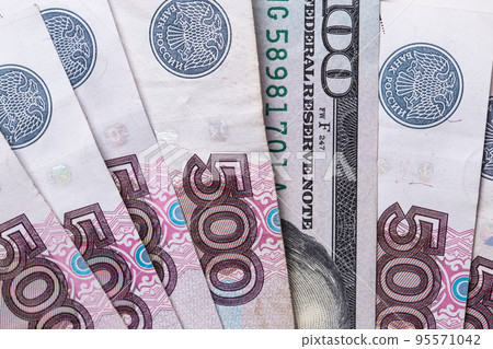 Ruble Russian currency and dollar close-up. Exchange rate. The dollar to ruble exchange rate Ruble Russian currency and dollar close-up. Exchange rate. The dollar to ruble exchange rate 95571042