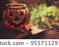 Halloween pumpkin glass candlestick with autumn leaves 95571129