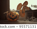 Laughing Halloween pumpkin glass candlestick with autumn leaves. 95571131