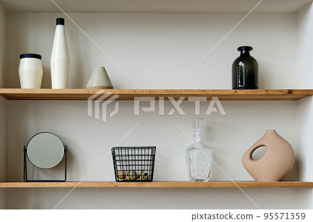 Two wooden shelves with decorative elements in the interior Two wooden shelves with decorative elements in the interior 95571359