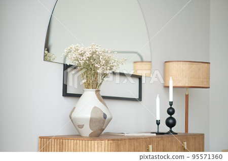 Vase with dry flowers in a modern interior Vase with dry flowers in a modern interior 95571360