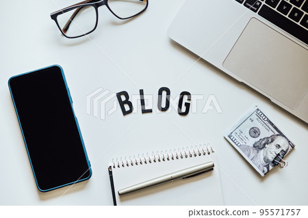 How To Start Blog, Blogging for Beginners. Ways to monetize your blog. Blog word on table with laptop, smartphone, open notebook, dollar banknotes and glasses 95571757