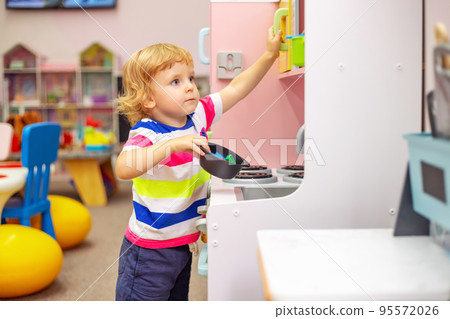 Child playing with colorful toys at the learning center or in kindergarten 95572026