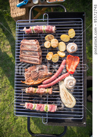 Top view of tasty BBQ food cooking on summer day 95572748