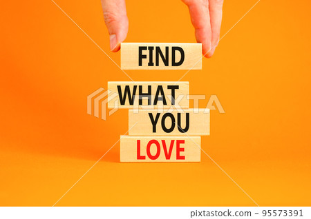 Find what you love symbol. Concept words Find what you love on wooden blocks. Beautiful orange table orange background. Businessman hand. Business, psychological find what you love concept. Copy space Find what you love symbol. Concept words Find what you love on wooden blocks. Beautiful orange table orange background. Businessman hand. Business, psychological find what you love concept. Copy space 95573391