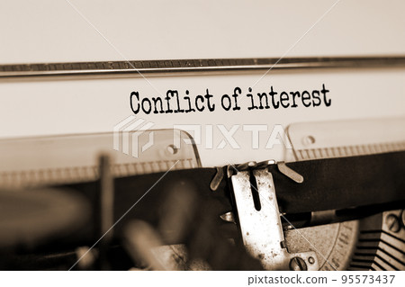 Text 'conflict of interest' typed on retro typewriter. Business concept. Beautiful background. Copy space. Text 'conflict of interest' typed on retro typewriter. Business concept. Beautiful background. Copy space. 95573437