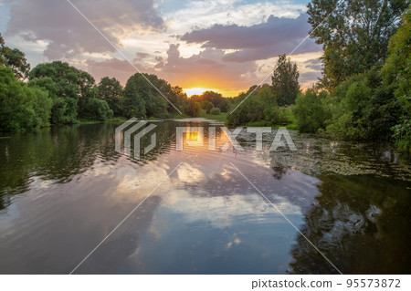Amazing Summertime in Moscow oblast -  lake and reflections in it  and sunset 95573872
