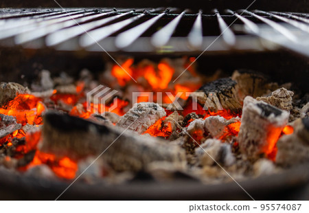 Stock image of charcoal fire grill, close up with live flames. Stock image of charcoal fire grill, close up with live flames. 95574087