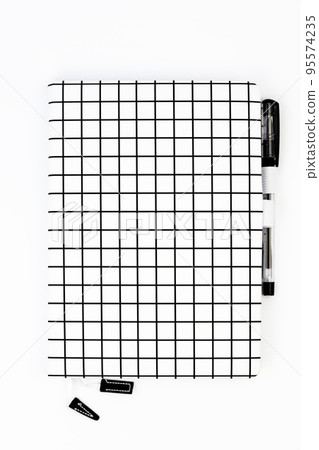 View from above. A notebook with a pen on a white background. View from above. A notebook with a pen on a white background. 95574235