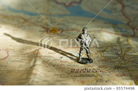 A figurine of an armed soldier on the map of Nagorno-Karabakh. 95574496